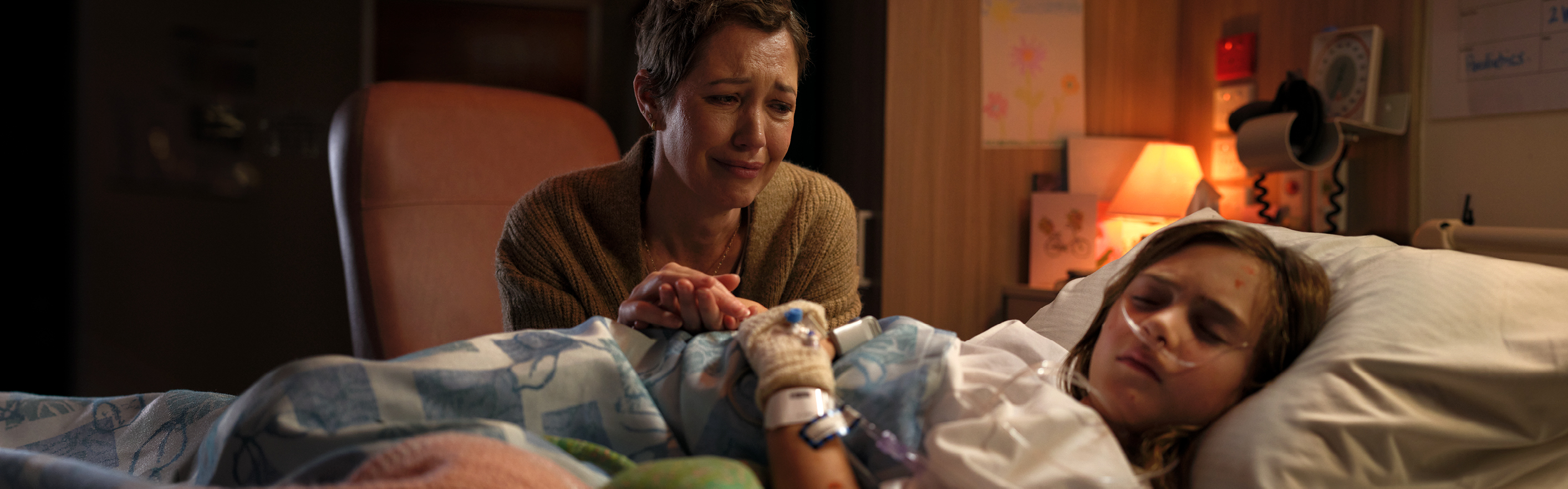 Woman at daughter's hospital bed