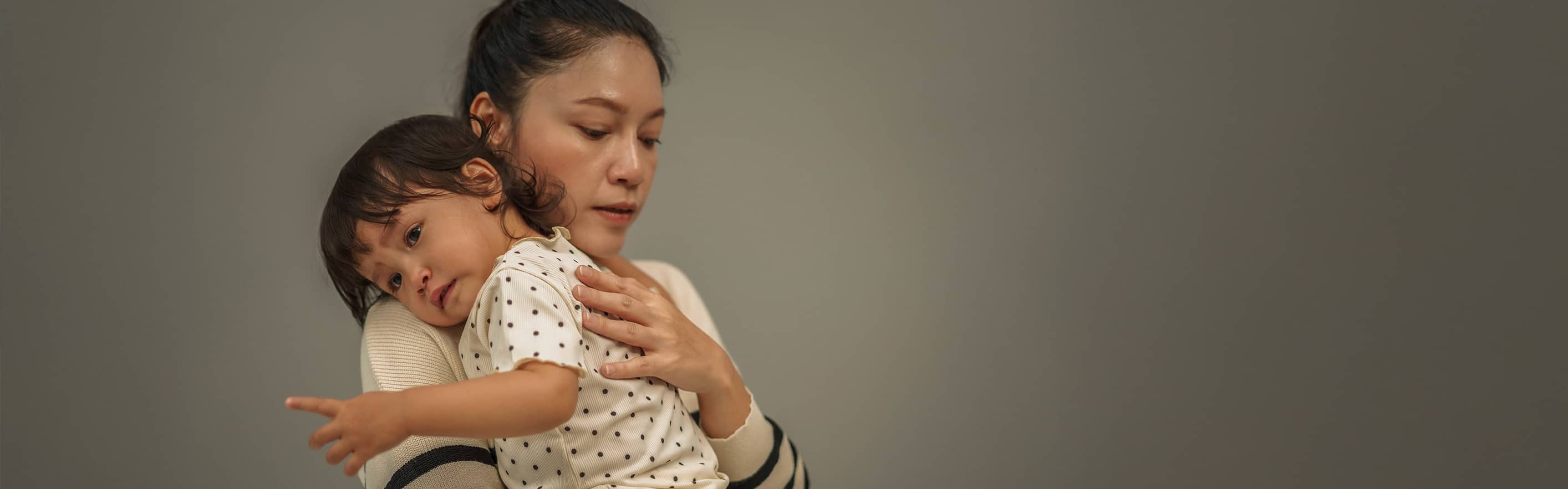 mother holding toddler