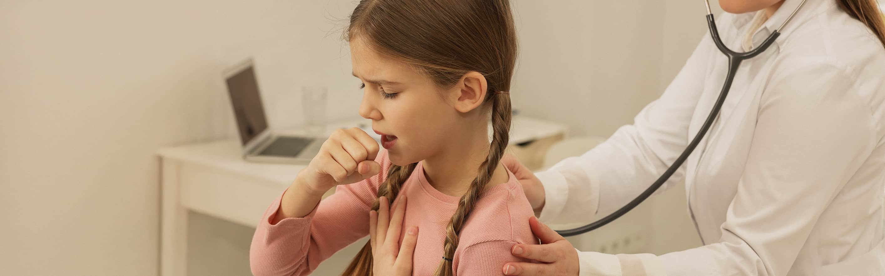little girl coughing at doctors office